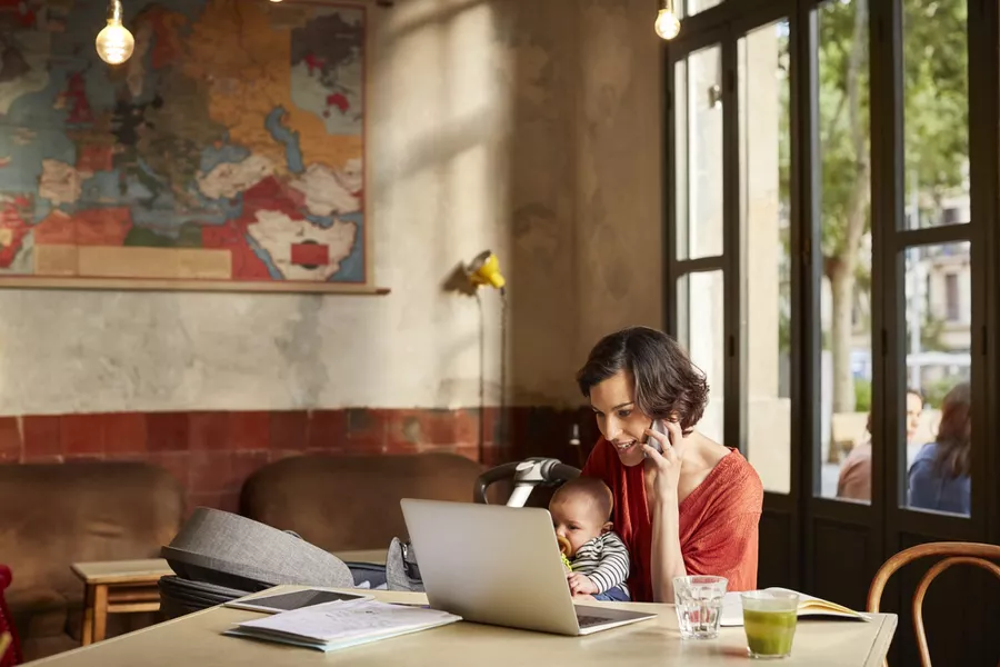 working parent in a coffee shop with baby